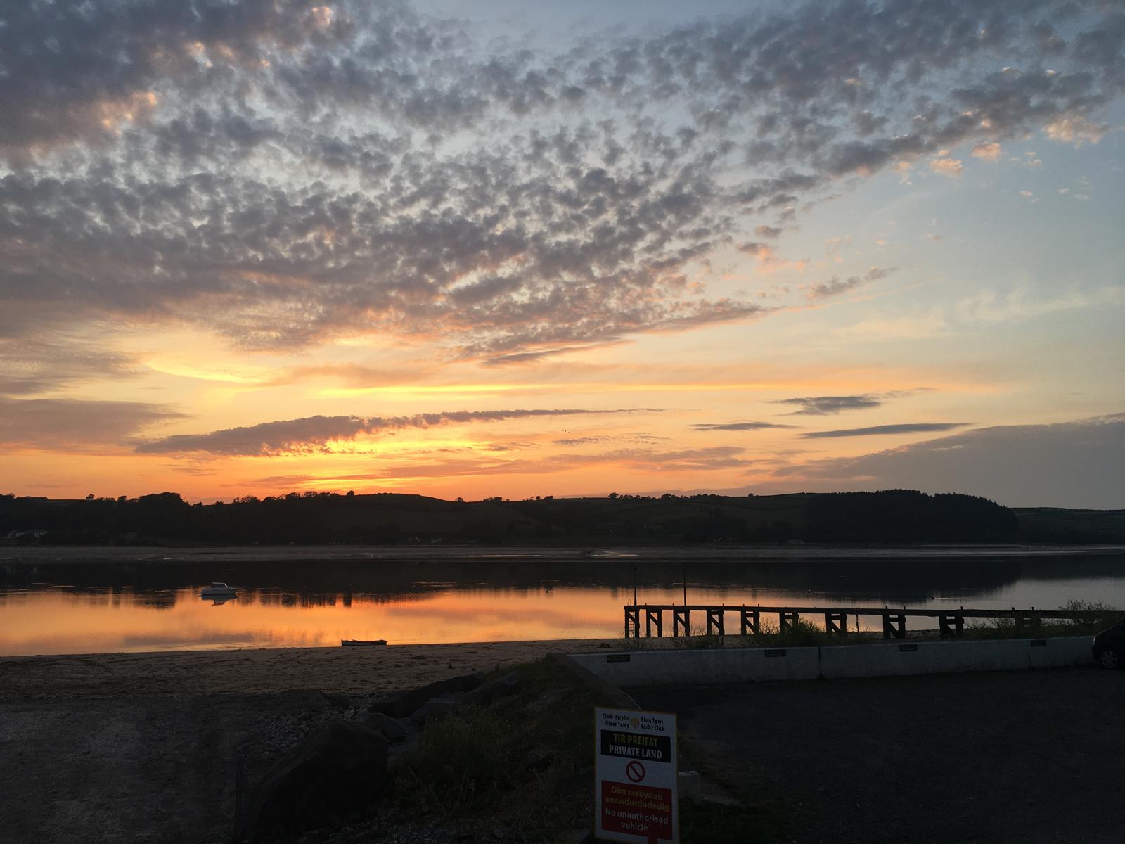 Sunset over quiet hills and water